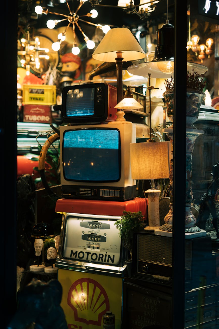 tvs and lamps in clattered vintage shop window