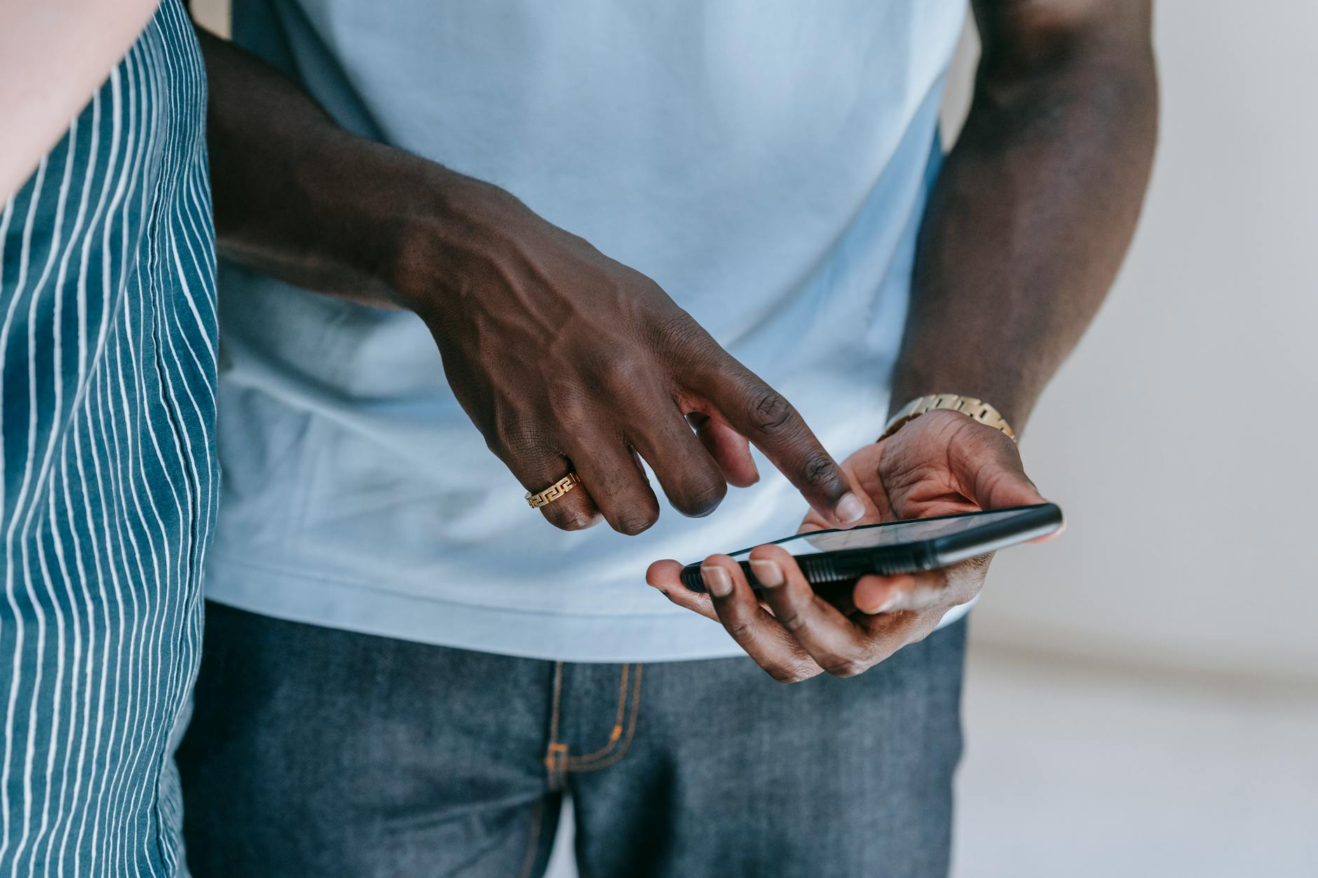 close up photo of a person holding cellphone using Black Excellence Daily app